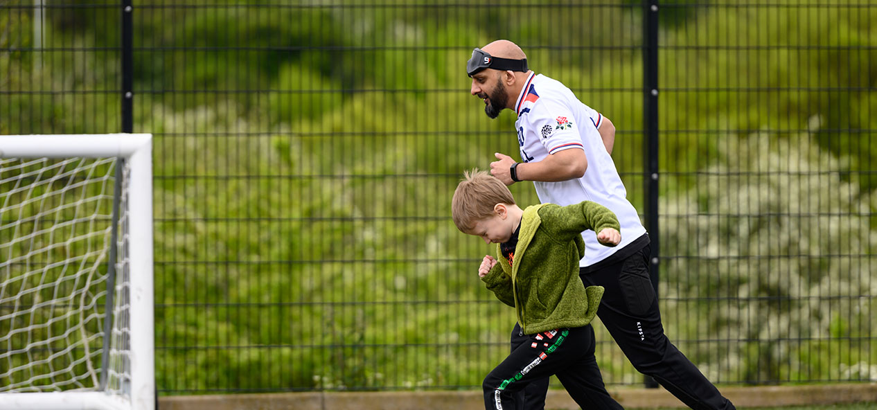 A man runs with a boy
