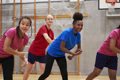 A group of teenage girls take part in an exercise class