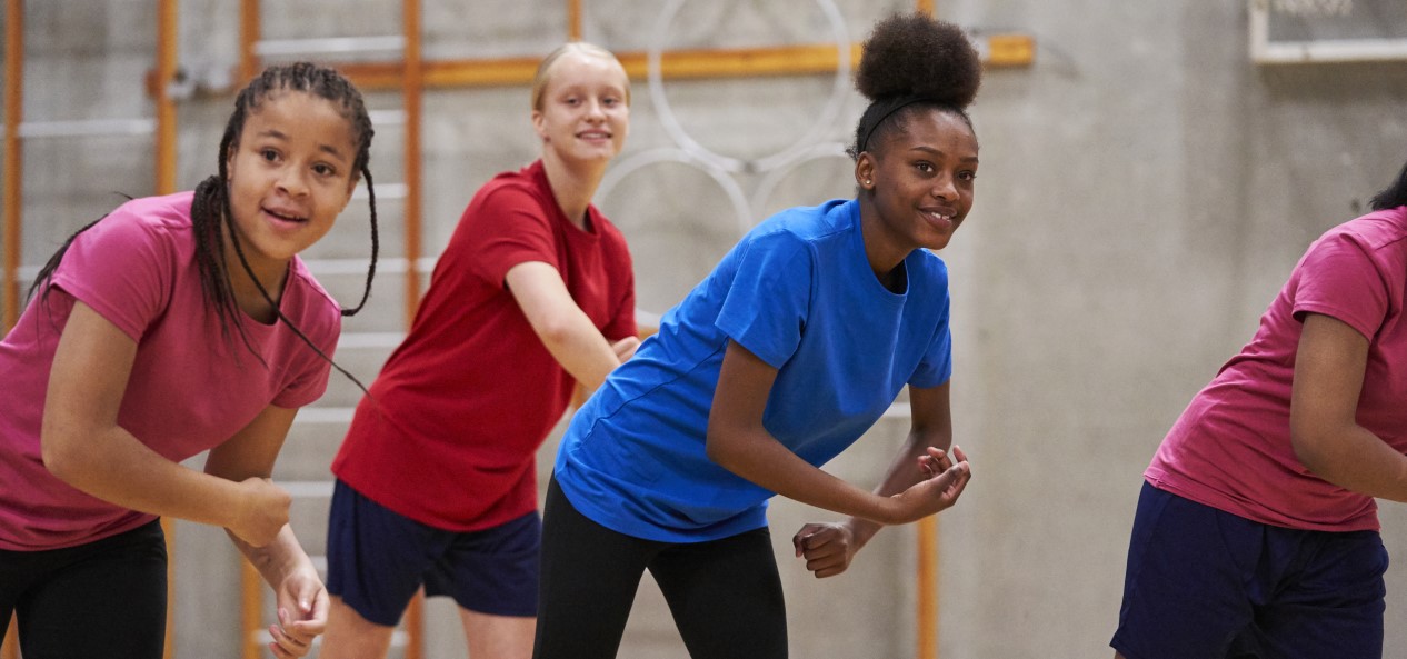 A group of teenage girls take part in an exercise class