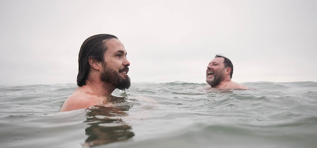 Two men swim in open water