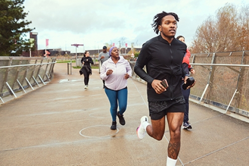 A group of people, run in a park