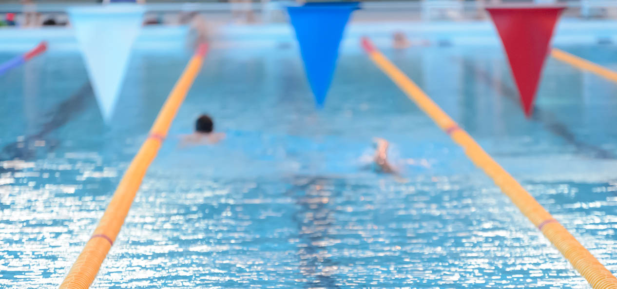 People swim lengths in a swimming pool