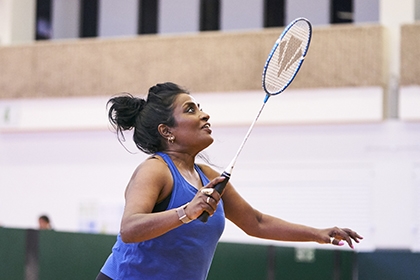 A woman playing badminton