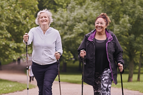 Two women going for a walk in the park