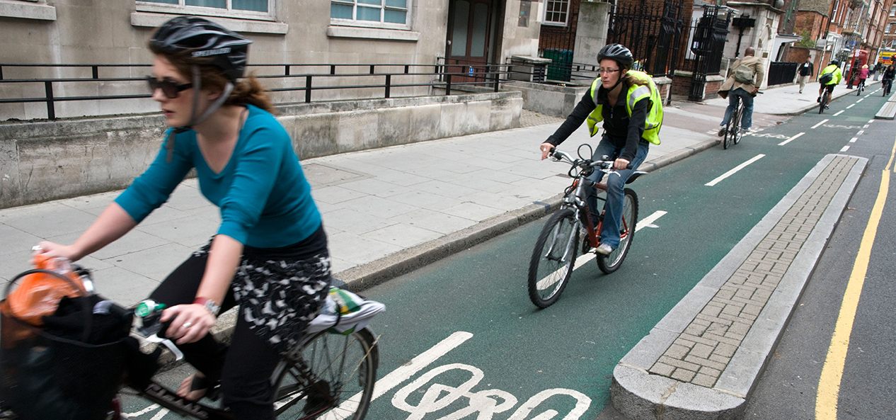 Cyclists ride on a segregated bike lane in London.