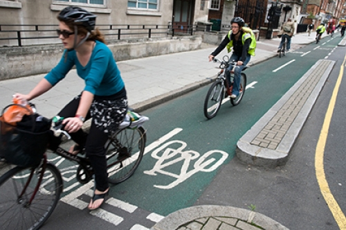 Cyclists ride on a segregated bike lane in London.