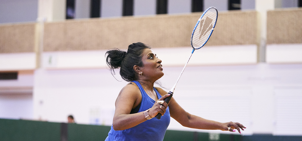 A woman playing badminton