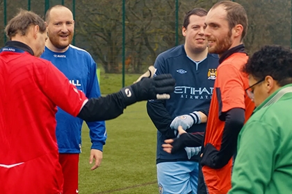 Members of Blokes United talk to each other on the pitch