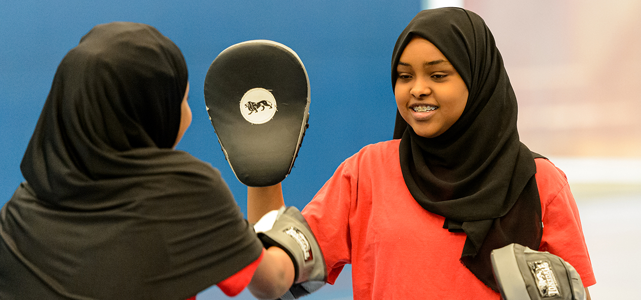 Two girls doing boxing pad work