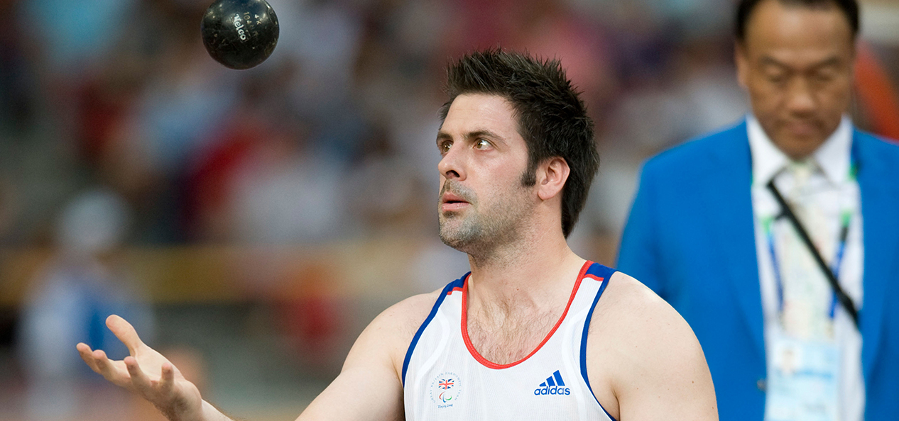 Daniel West, para shot putter, throws his shot put into the air and looks to catch it as he prepares to compete at the Beijing 2008 Paralympic Games