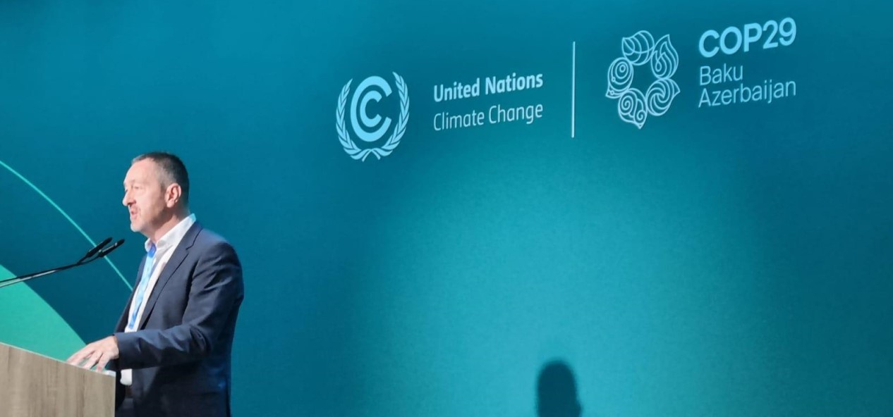 Chris Boardman speaks at a lectern during COP29 in Azerbaijan.