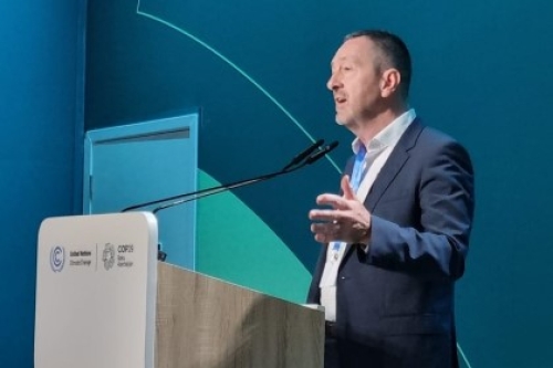 Chris Boardman speaks at a lectern during COP29 in Azerbaijan.