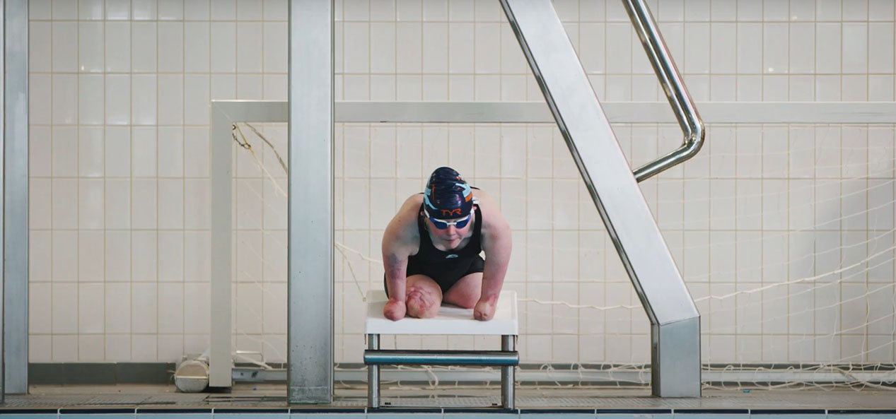 Para swimmer Ellie Challis prepares to dive into a swimming pool