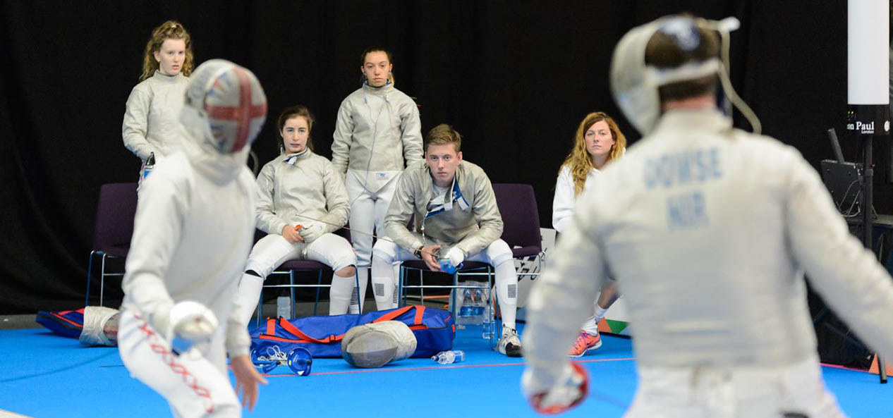 Young fencers watch a contest