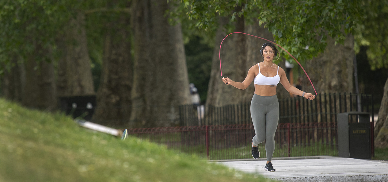 A women skips in the park