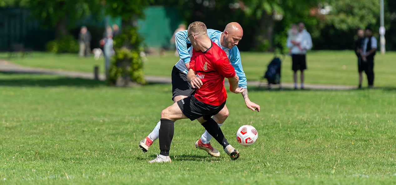 Two men playing football 