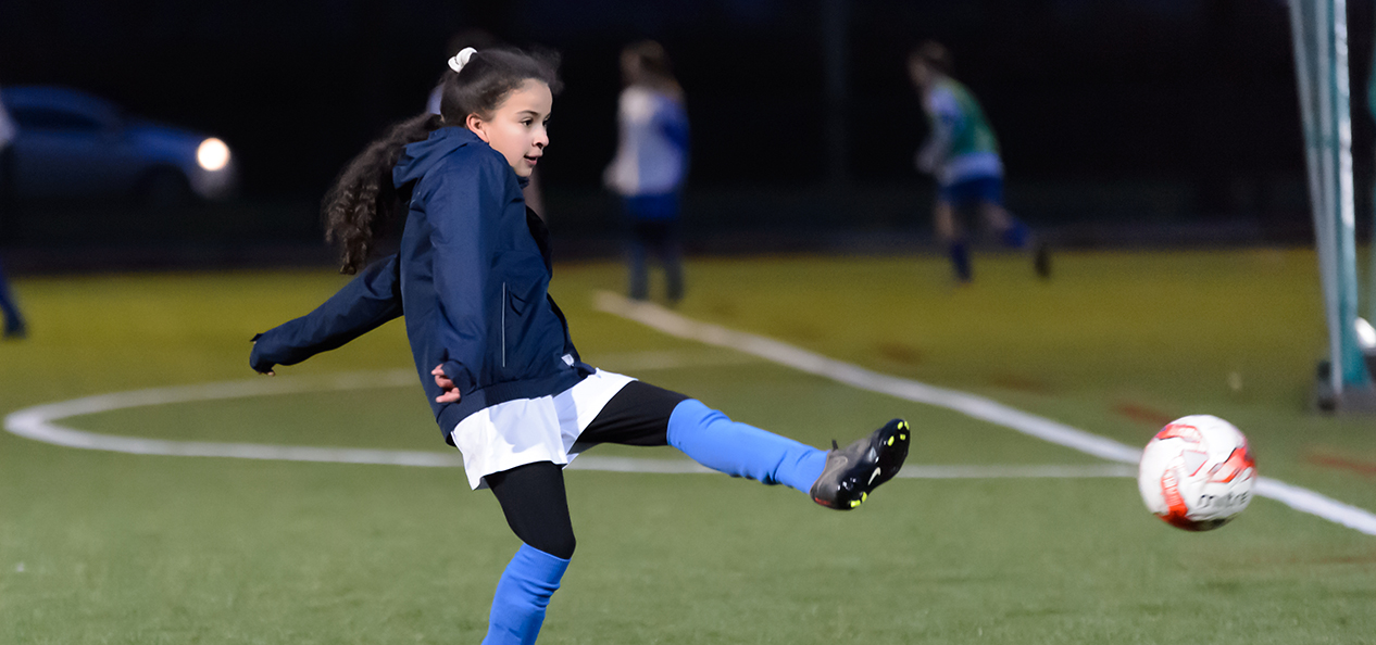 A girl playing football 