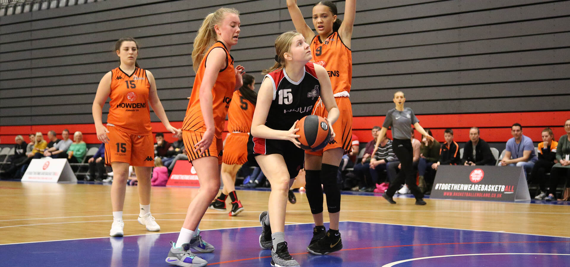 Girls guarding shooter during basketball game