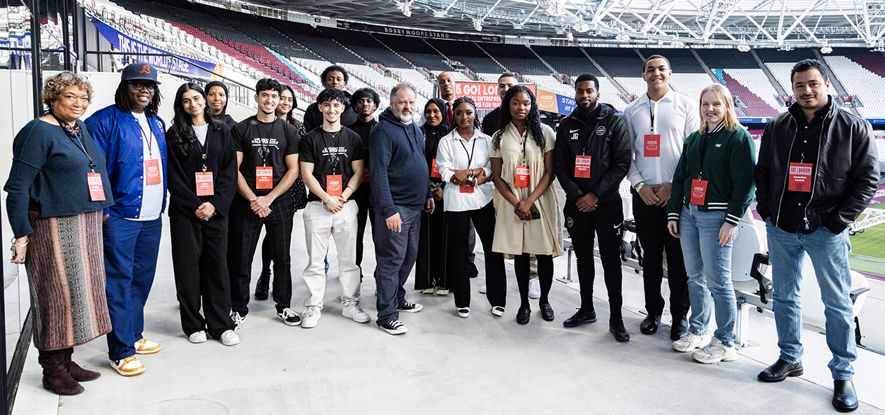 Winners and judges of the Go! London Young Entrepreneurs competition pose for a photo at London Stadium