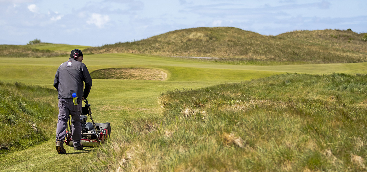 A groundsperson gets a golf course ready for action.