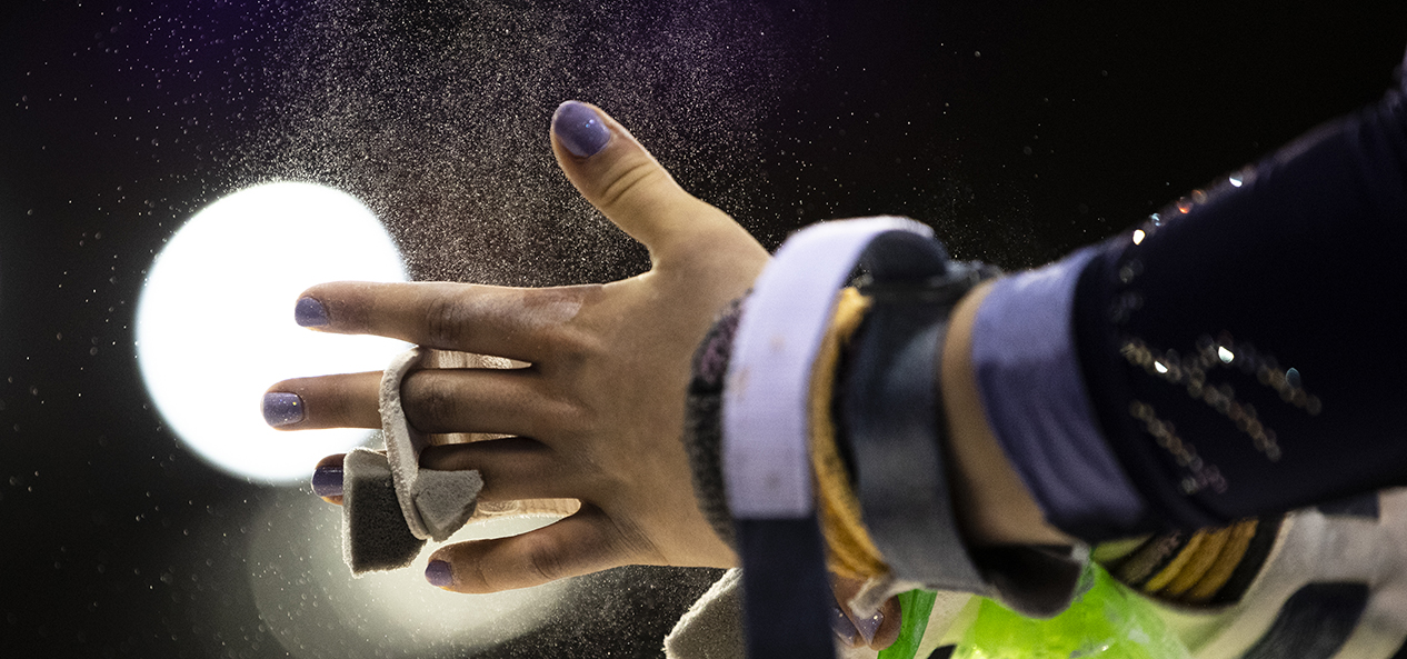 A gymnast rubs her hands