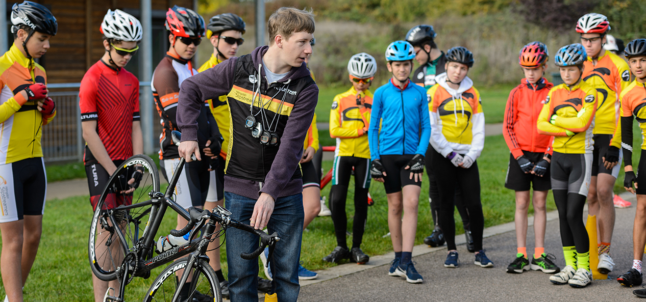 A volunteer helping out at a cycling event.