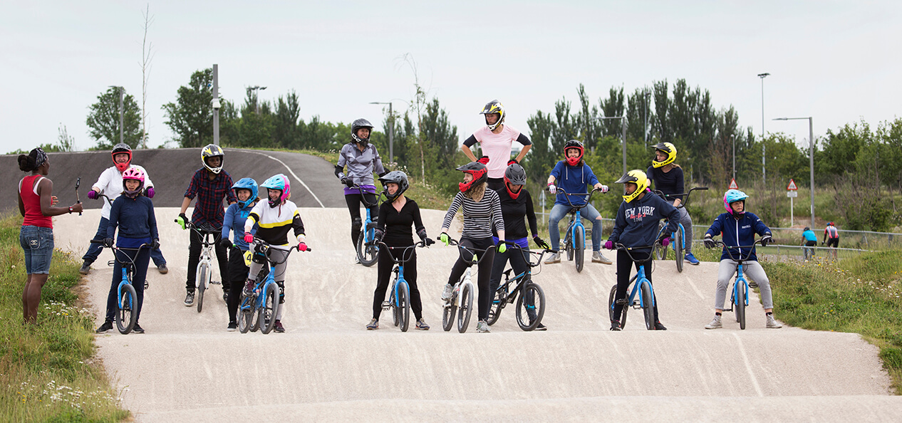 A group of cyclists line up on a BMX track