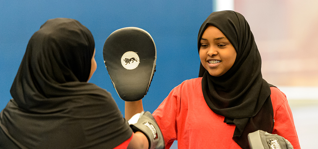 Two girls doing boxing pad work