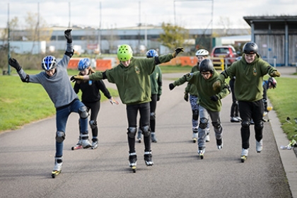 Teenagers try out Nordic skiing, on roller skis