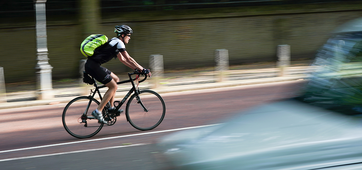 A man cycling in a cycle lane.