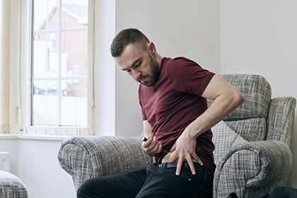 A man using a diabetes pen.