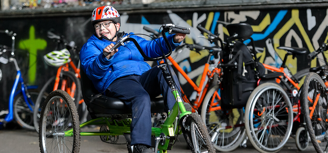 A boy cycling outdoors.