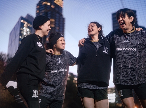 A group of women hold a team talk in a football match