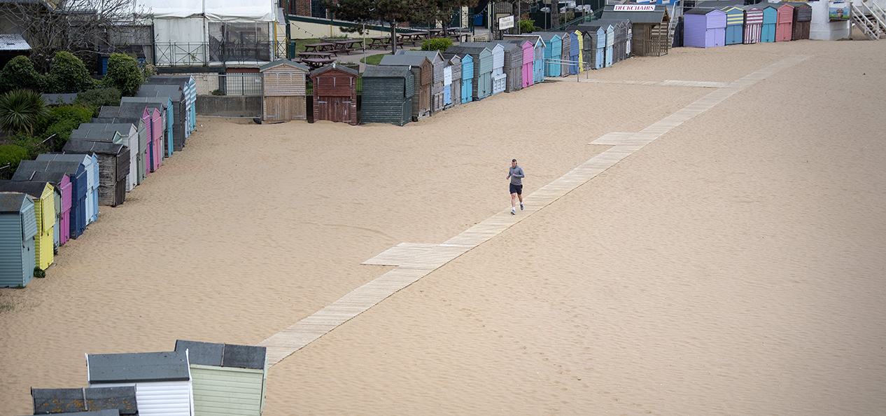 A man runs alone on Broadstairs beach, Kent