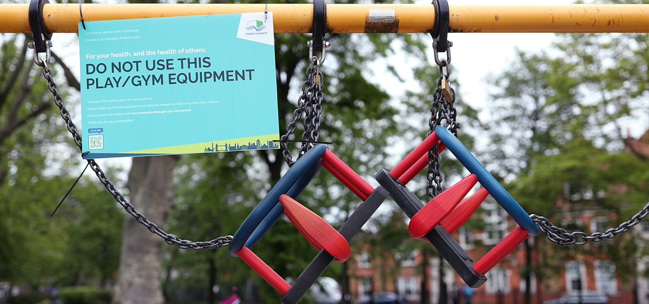 A sign on a children's swing saying do not use, due to coronavirus restrictions