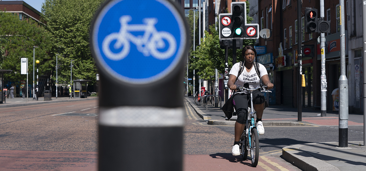 A woman cycles in a cycle lane in Manchester.