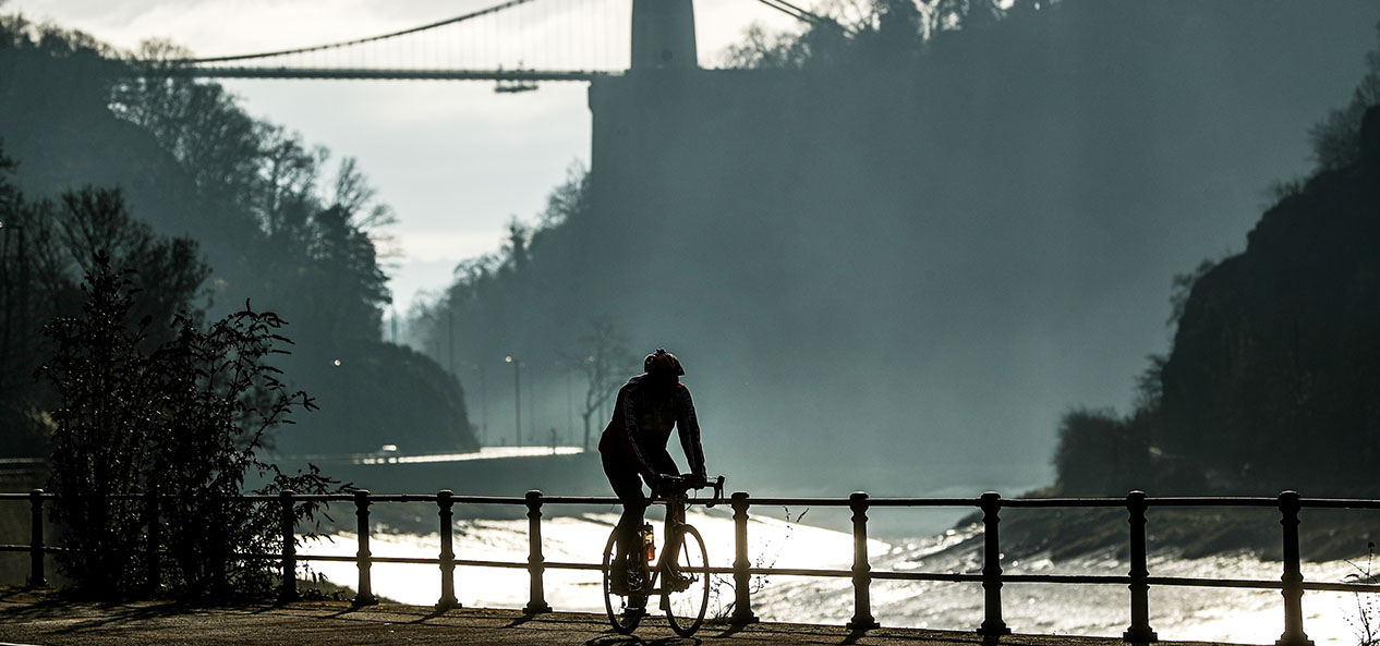 A person rides their bike by the River Avon in Bristol