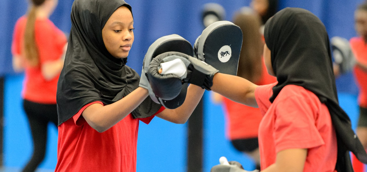 Girls do boxing training indoors