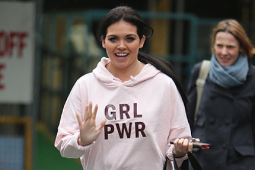 Former Gogglebox star Scarlett Moffatt waves at the camera, wearing a hoodie with 'GRL PWR' on it.