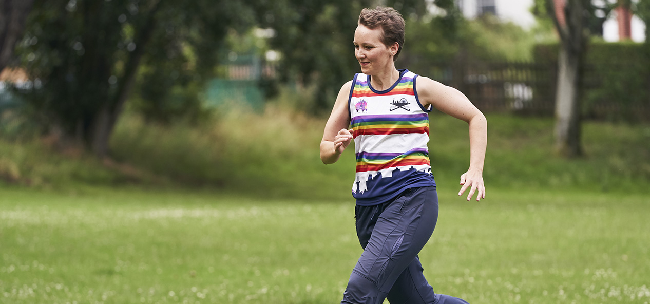 A woman runs on a playing field