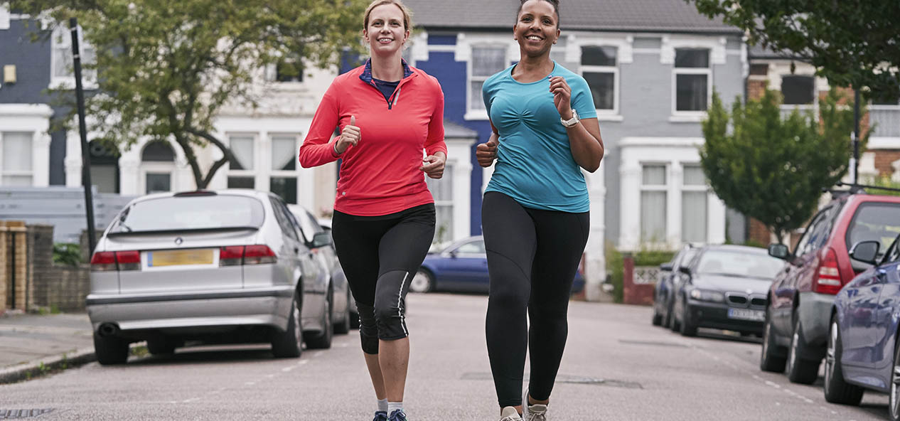 Two women running along a road