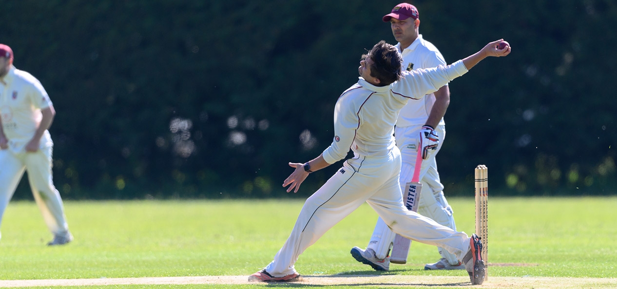 A man bowls the ball during a local league cricket match