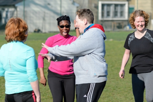 Group of women laughing and enjoying sport outdoors