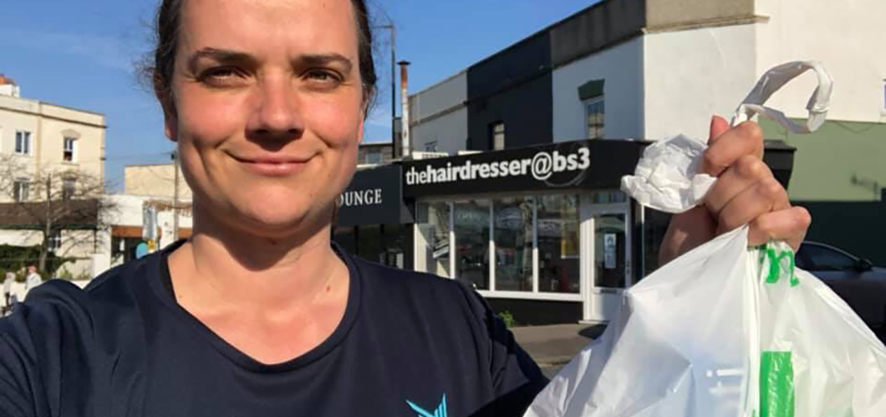 A This Mum Runs volunteer holds a pharmacy bag during a delivery to a vulnerable person