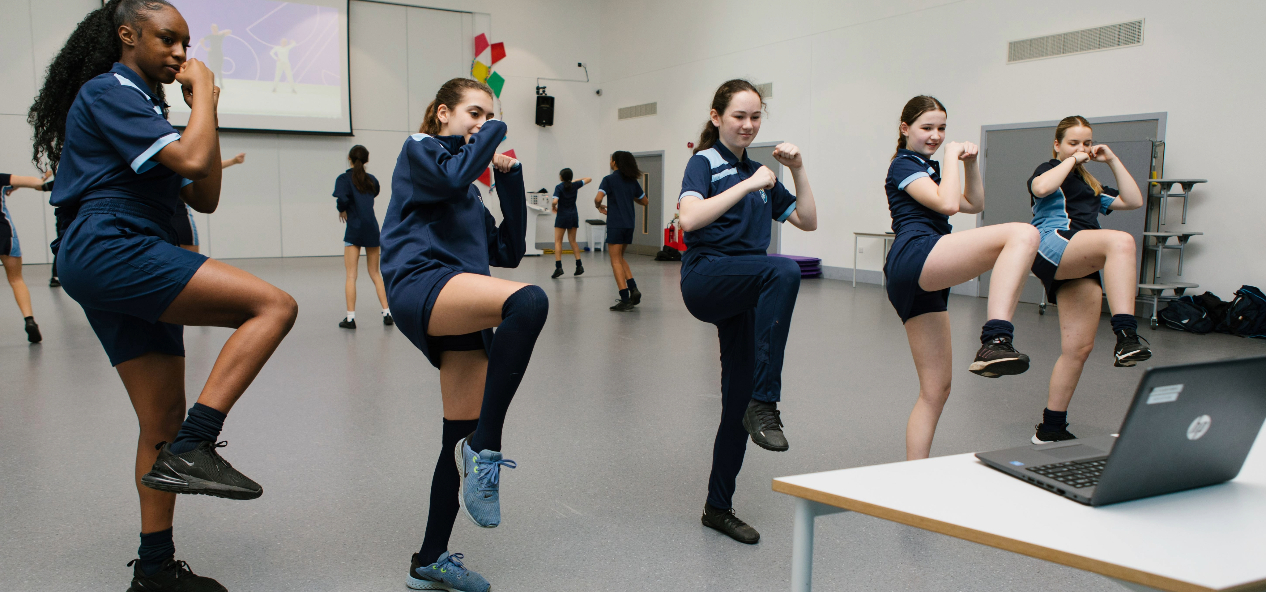 Teenage girls enjoying Studio You class at school