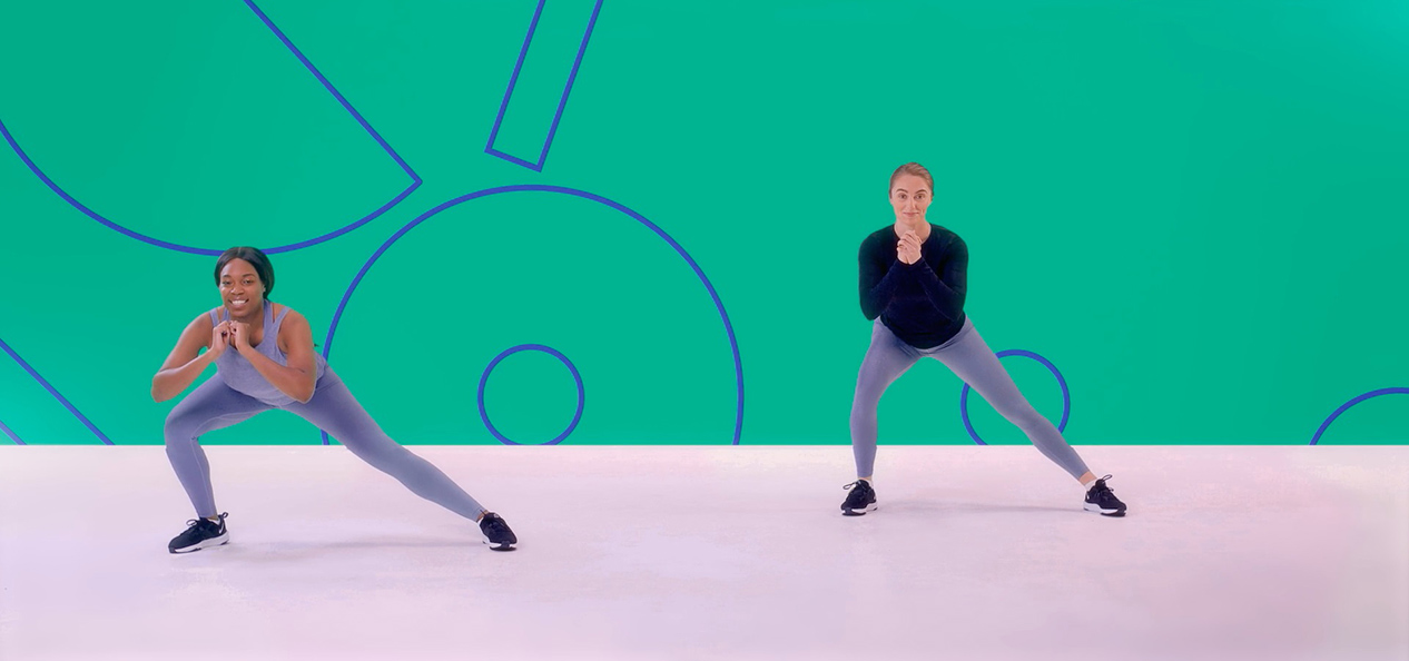 Two girls perform side lunges in an exercise class as part of a Studio You video