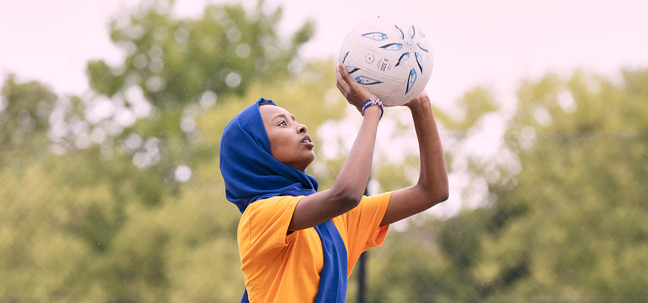 A woman playing netball