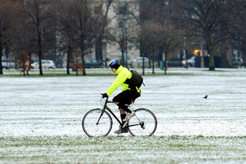 A man cycles in the snow