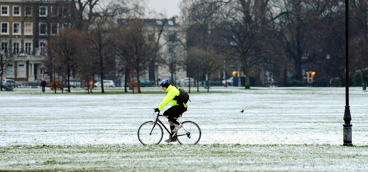 A man cycles in the snow