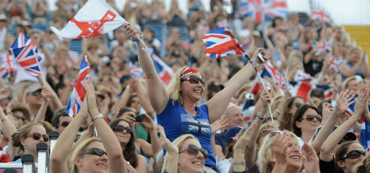 Audience cheering waving England flag